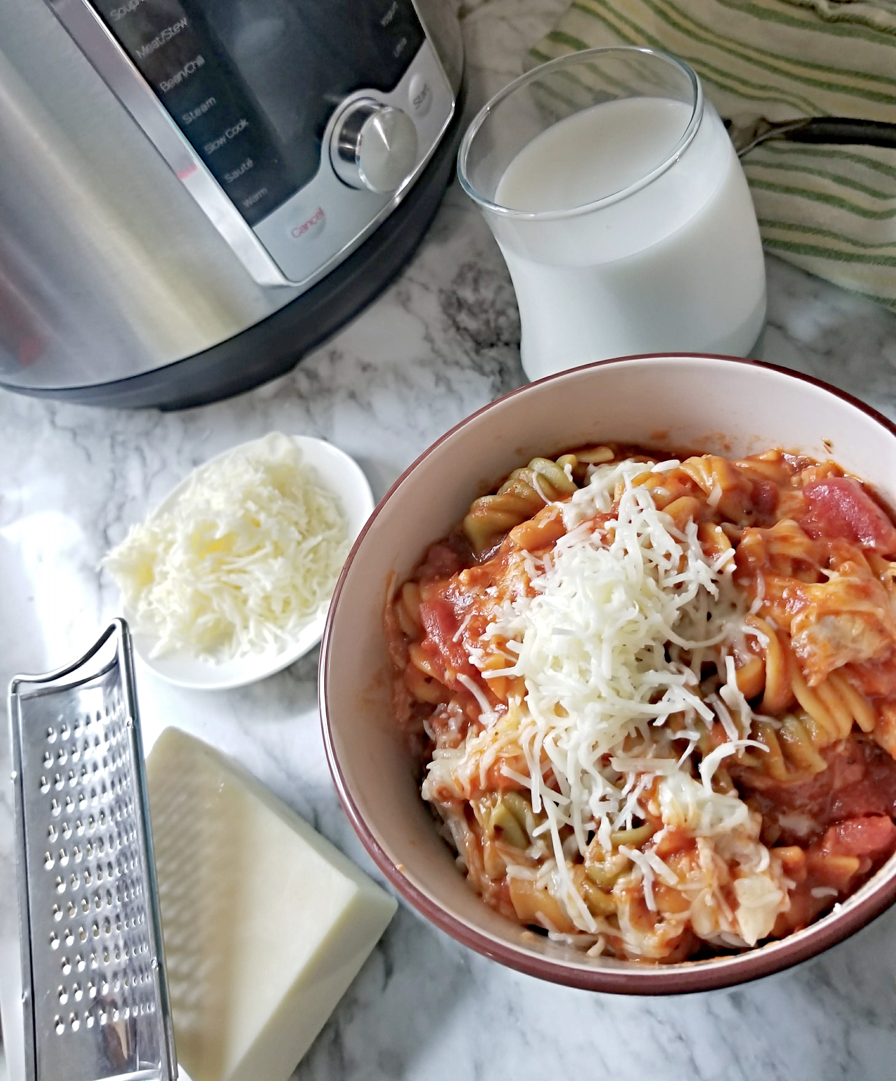Instant Pot Chicken Marinara Rotini in bowl with cheese and milk 